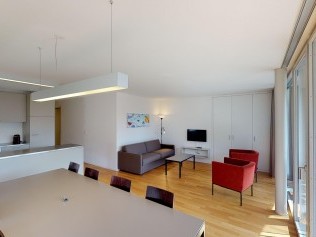 Living room with dining area - Reka Holiday Village Blatten