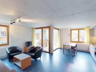 Living room with dining area - Reka Holiday Village Disentis