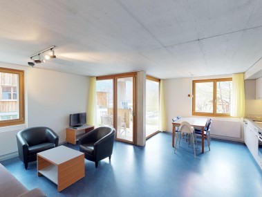 Living room with dining area - Reka Holiday Village Disentis