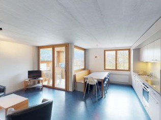 Living room with dining area - Reka Holiday Village Disentis