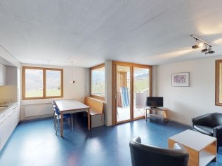 Living room with dining area  - Reka Holiday Village Disentis