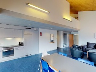 Living room with dining area - Reka Holiday Village Disentis