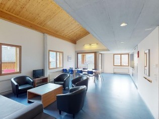 Living room with dining area - Reka Holiday Village Disentis