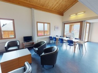 Living room with dining area - Reka Holiday Village Disentis