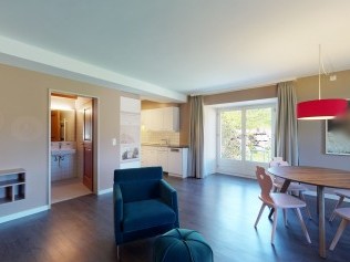 Wohnzimmer mit Essbereich - Reka-Ferienanlage Chesa Engadina Madulain